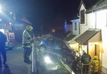 Driver has lucky escape after freak crash leaves car hanging