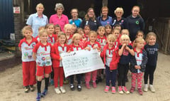 Rainbows present fundraising pot of gold to Erme Valley RDA