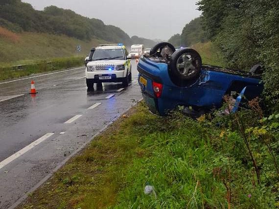 Car ends up on roof in heavy rain on A38