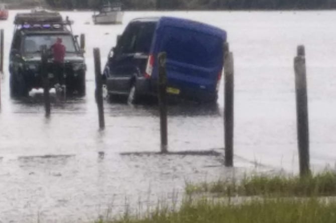 A van comes off the tidal road at Aveton Gifford