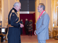 Former CEO presented with CBE in intimate Windsor Castle ceremony 