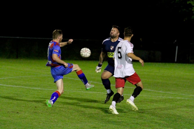 Alfie Slough bundles the ball past onrushing goalkeeper Scott Corderoy Credit: Josh Goodman