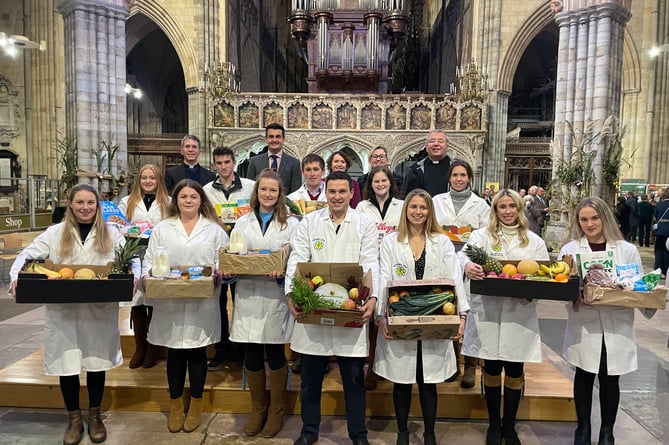 The YFC representatives with the offerings made during the service, with, back row, from left, Canon Chris Palmer, Paul Glanville, Deputy Lord Mayor of Exeter, Cllr Tess Read, Vicki Gilbert and Dean, the Very Rev Jonathan Greener.  AQ 9586