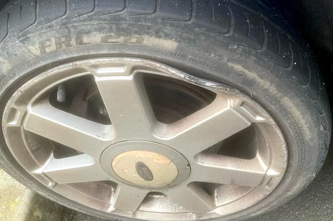 A wheel rim damaged by a pothole