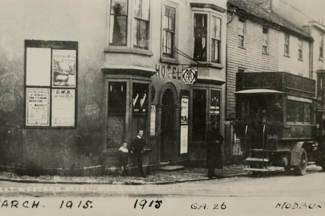 1915 Bus GA 26 and driver outside Great Western Hotel, Modbury. 
Later  name changed to the Red Devon Hotel, and eventually demolished for road widening.