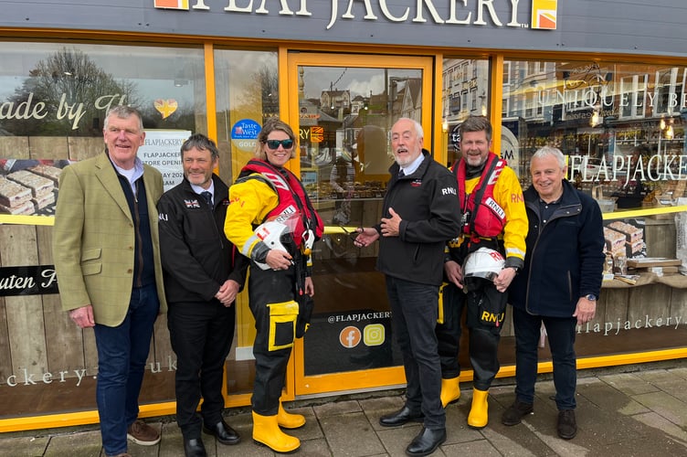 Dart RNLI operations manager Michael Bryant-Mole cuts the ribbon at the opening with, left to right, Flapjackery's Hugh Myott, Dart volunteers Mark Strudwick, Tatty Pettigrew and Stuart Millard, and Ian MacQueen of Flapjackery.