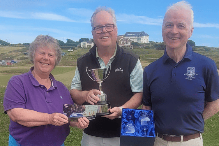 Ladies' captain Pam Adams with Toby Downer and club captain Jim Stewart presenting him with the Mixed Open Cup, Vouchers and Goblets