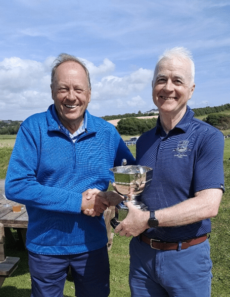 Don Thompson (left) is presented with the Allcomers Cup by Thurlestone club captain Jim Stewart