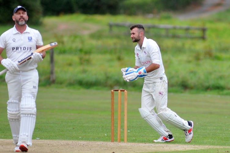 Devon Cricket League D Division West.  Kenn versus Dartington and Totnes. A wry grin from D&T 'keeper Alex Perkin as Kenn skipper James Mason is caught out by Justin Osborne from a ball by Alastair Selby