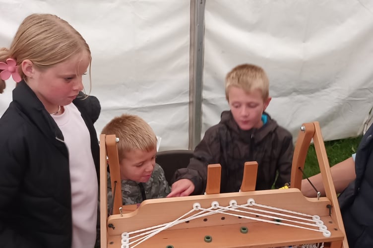 Flor Maclachlan, 10, Albie Davis 5, Harry Davis 8 weaving at the Kingsbridge Show