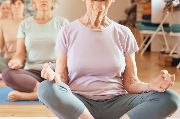 Yoga, exercise and senior woman in lotus for meditation, mindfulness and zen workout for health and wellness in retirement. Group of older people together yoga spiritual, chakra and balance training