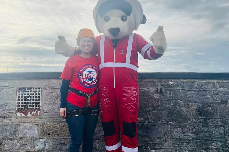 Brave Rebecca Smith, SW Devon MP, abseiled down Plymouth Citadel with the Devon Air Ambulance mascot.