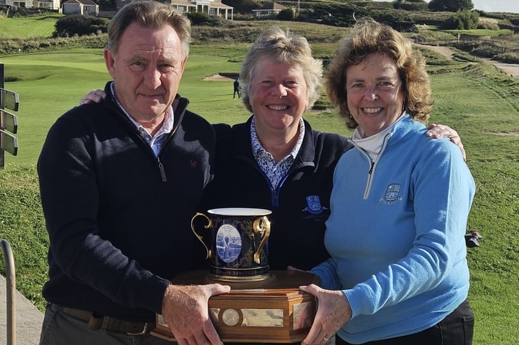 Pam Adams (Centre) presents the Foundation Trophy to Alec and Sue Esplin