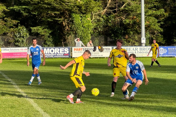 Crediton, in blue, and Stoke Gabriel and Torbay Police, going for the ball. AQ 6326