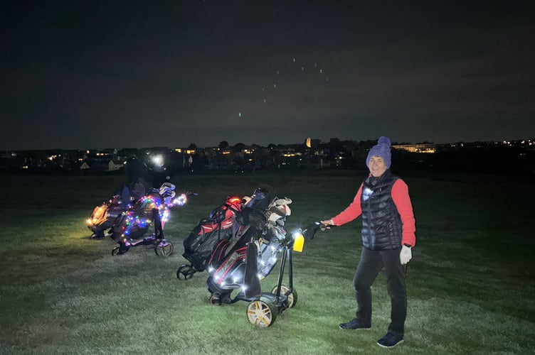 Night golf competitor Liz Stewart with colourful trollies at Thurlestone to raise money for the  Devon Air Ambulance