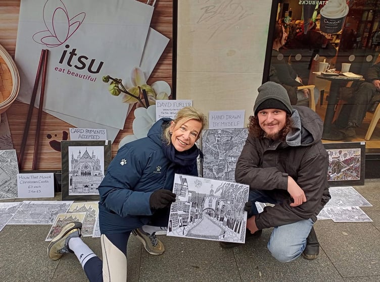David Furler posing with Katie Hopkins and the print he sold her, depicting Totnes