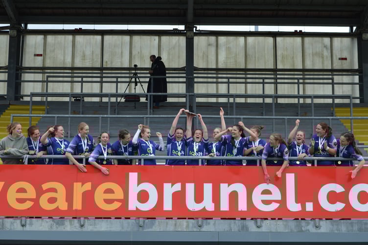 Kingsbridge RFC U18 girls hoist the Devon Plate