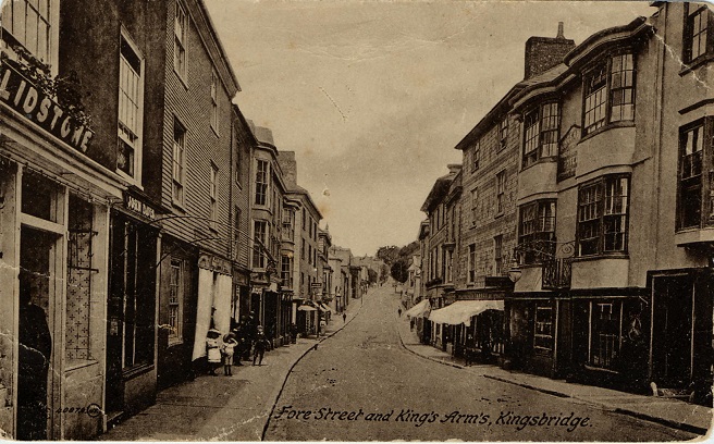 1910 view north up Fore Street, Kingsbridge. 
Includes Kings Arms, Lidstones, John Davis and Tanners