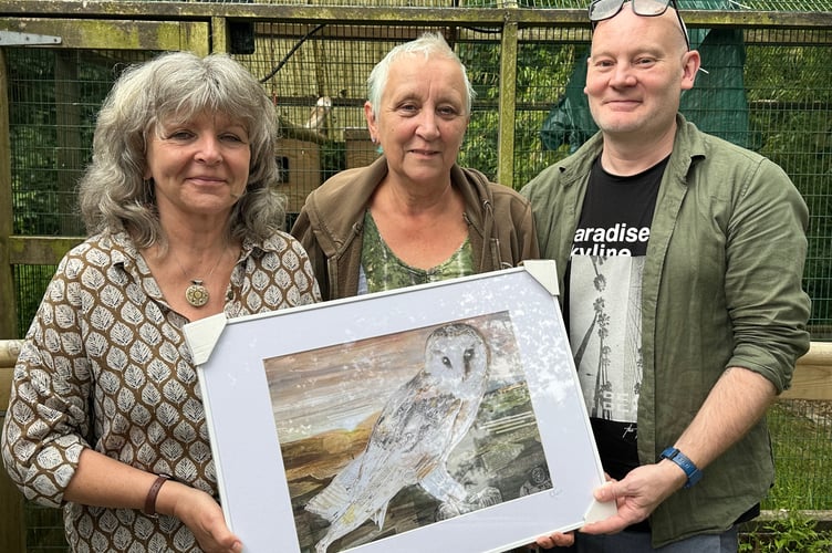 Artist Glen Middleham presenting the print to Barn Owl Trust staff