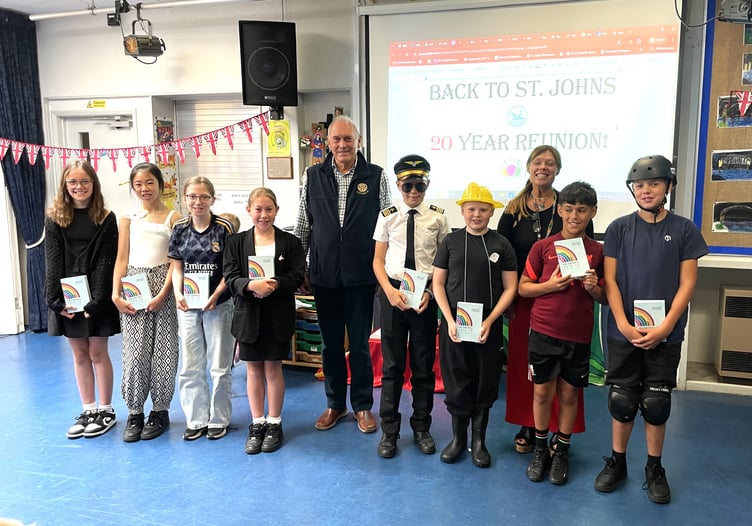 Some year 6 pupils at St John the Baptist Primary School, Dartmouth, and their teacher, Mrs Brown, after receiving their “Book for Life” from Bernard Young President of Dartmouth Rotary at their final assembly.