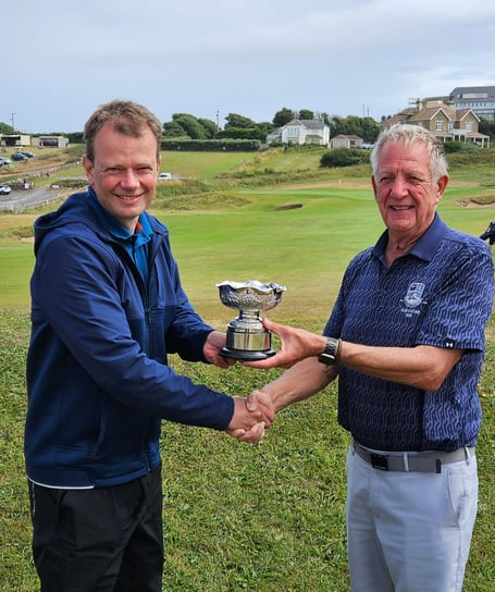 Graham Cup winner Chris Watt receives his prize from club captain John Rogers