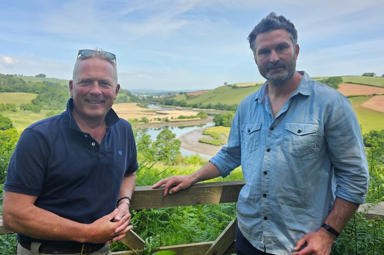 Presenter Jules Hudson (left) in front of the rewilding fields on The Sharpham Estate with Jack Skuse (right), of Ambios Ltd - The Sharpham Estate-based nature conservation organisation building and placing osprey nests on The Sharpham Estate. 