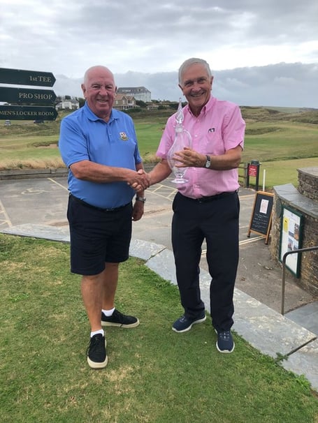 Thurlestone match captain Bill Campbell receiving the trophy from John Harding, Bigbury captain.