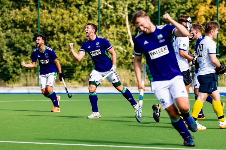 ARich Fisher (centre) celebrates his last second strike which won the match for Ashmoor against Team Bath