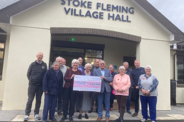 Caroline Voaden MP presents the cheque to villagers