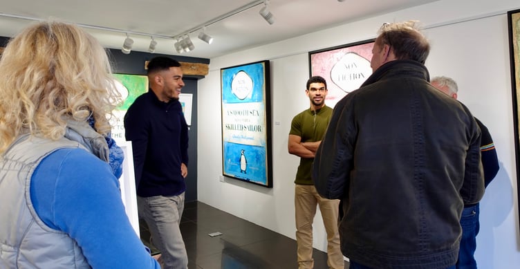Artist duo, Charles Hollywood, talking with visitors at the opening of their exhibition at The Drang Art Gallery in Salcombe.