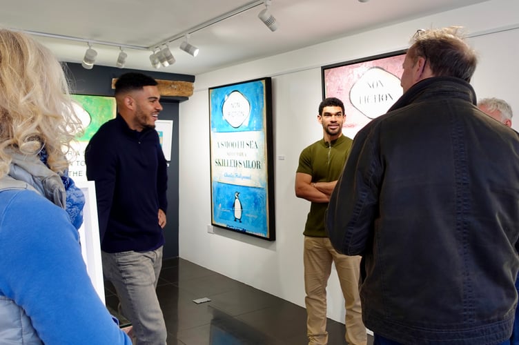 Artist duo, Charles Hollywood, talking with visitors at the opening of their exhibition at The Drang Art Gallery in Salcombe.