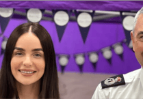 Top Cop in deep water with sharks