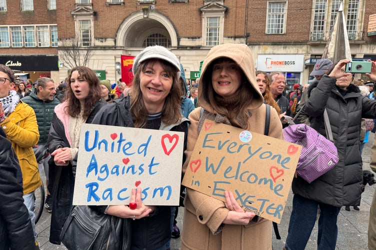 Two people with placards in the Exeter is for Everyone march.  AQ 8749
