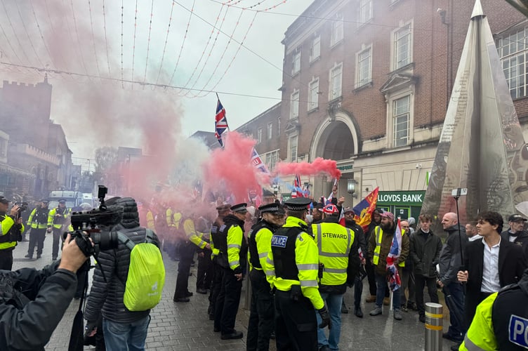 Red, white and blue flares were let off by British Unity March protesters upon arrival at Bedford Square.  AQ 8779
