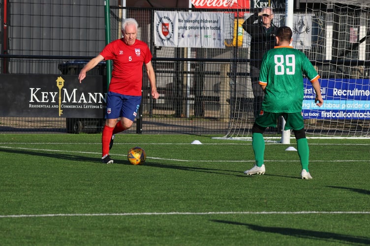 Paul (in red) playing in the England V Republic of Ireland game