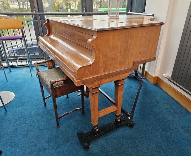 Watermark giving away baby grand piano 