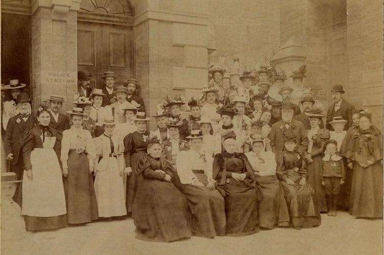 Around 1890  group of men and women gathered in front of Town Hall  and steps to St Edmund’s Church, Fore Street, Kingsbridge. 