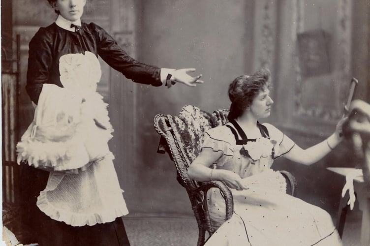 Scene from a play at the Town Hall, Fore Street, Kingsbridge. Two women in costume