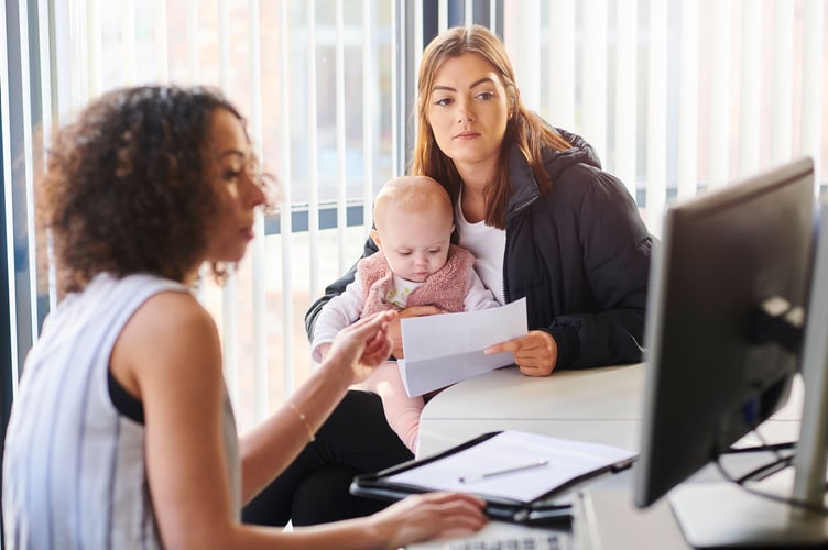 Young mother with social services or housing officer.