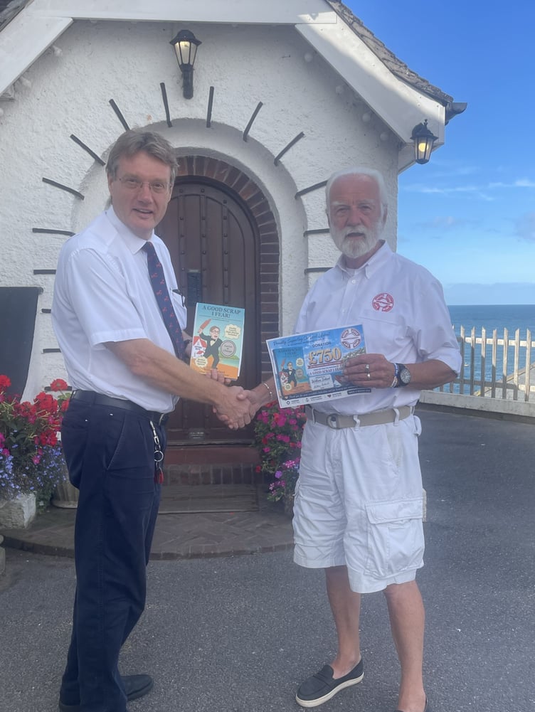 Author William Ireland presents Hope Cove Lifeboat Chairman Steve Bagulay with £750