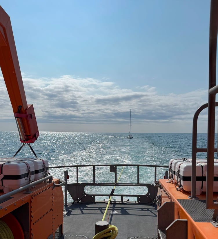 The relief Severn class all-weather lifeboat Christopher Pearce tows the sailing vessel